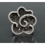 A contemporary certified fancy black and white diamond flower head dress ring,