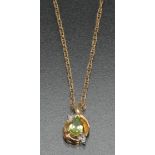 A peridot and diamond pendant necklace, vibrant green pear drop peridot open framed,