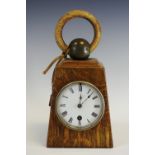 An early 20th century novelty oak clock, in the form of a weight, 9cm white enamelled dial,