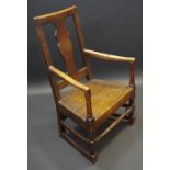 A late 18th century oak open armchair, vascular splat, wooden seat, turned uprights and stretcher,