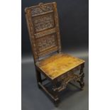 An 18th century oak side chair, the rectangular back carved with ivory, arched front rail, part c.