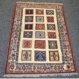 A Sozani rug, the field inset with three rows of of coloured squares, conforming borders,