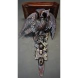 A Black Forest wall sconce carved with a heron and fruit.