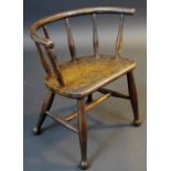 A 19th century child’s primitive Windsor chair, bowed cresting rail above a row of spindles,