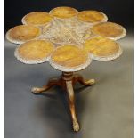 A George III style mahogany supper table, flowerhead top with dish rings turning on vasular column,
