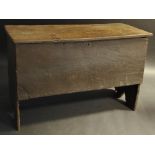 A late 17th century oak blanket chest, of plank construction, hinged top, with knotched edges,