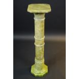 A 20th century onyx torchere, canted square top, ring turned column, 99cm high.