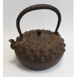 A 19th century Japanese iron tetsubin, hobnail cast, with cover, character marks beneath spout,