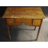 A George III oak lowboy, the oversailing moulded top above three faux cockbeaded drawers,