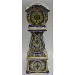A Delft miniature longcase, 7cm dial wit Arabic numerals, the case case foliage and flowers,
