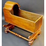 A 19th century mahogany rocking cradle, arched canopy, shaped sides,conforming sledge base, c.