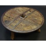 Up-cycling - a novelty occasional table, the top formed from and Asian wagon wheel, iron bound,