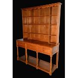 Wilf Hutchinson, Squirrelman - an oak dresser, moulded cornice above an arrangement of shelves,