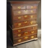 An 18th century oak chest on chest, moulded cornice with blind fret frieze,
