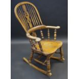 A 19th century ash and elm rocking chair, high hooped back, pierced vasular splat,