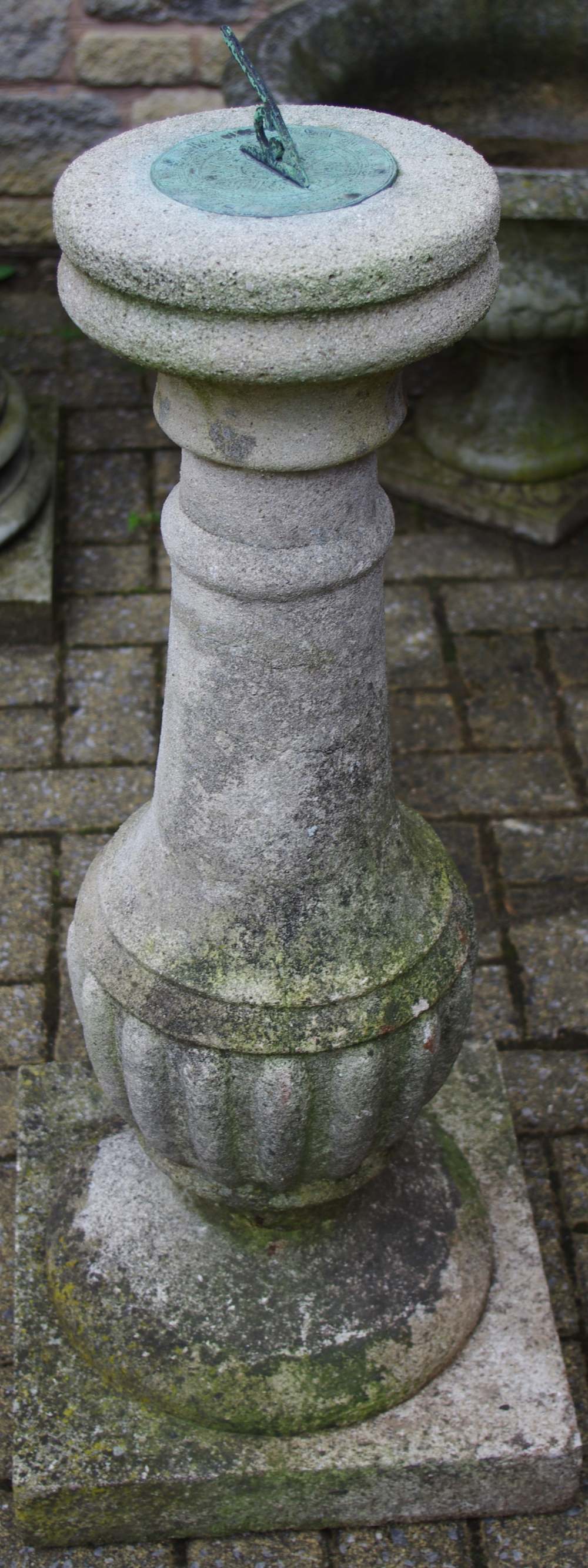 A reconstituted stone sun dial, fluted column, square base,