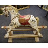 An early 20th century rocking horse, painted dapple grey markings, horse hair mane and tail,