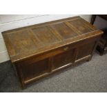 An 18th century oak blanket box, four panel hinged cover, three panels to front, stile feet,