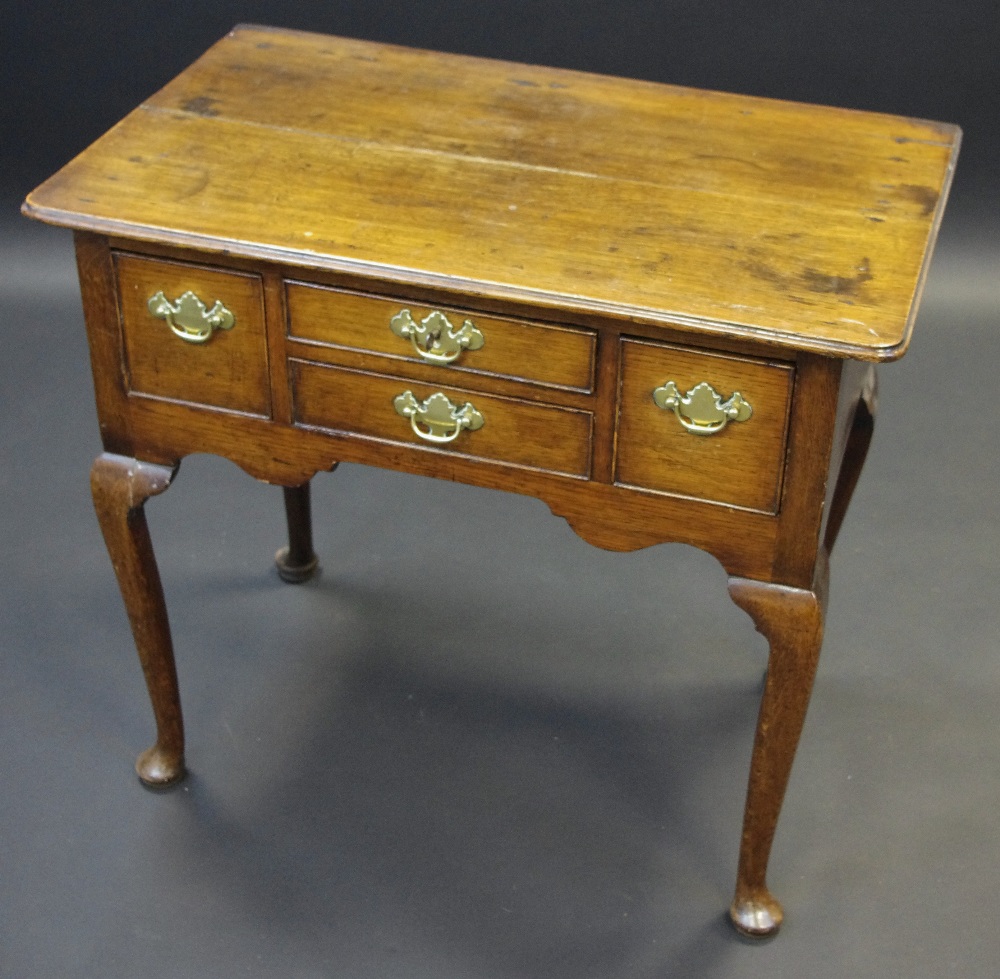 A George III oak low boy, moulded top, four short drawers to frieze, cabriole legs, 72cm high,
