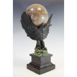 A 19th century desk bronze, of a eagle with wings outstretched, holding a marble globe, square base,