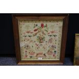 A late 19th century needlework sampler, embroidered with fanciful birds,