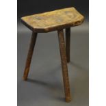 A 19th century rustic stool, three turned legs,