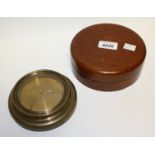 An early 20th century brass and mahogany circular vial spirit level, push-fitting cover, 15.