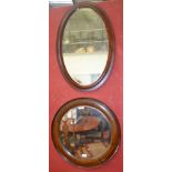 An Edwardian oval wall mirror,