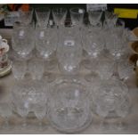 A suite of late 19th century cut glass drinking glasses, comprising rummers,