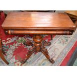 A 19th century mahogany tea table, hinged rounded rectangular top, substantial turned column,