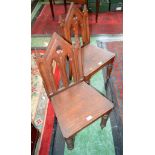 A pair of Gothic Revival oak hall chairs, architectural pierced and carved backs, boarded seat,