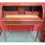 A 20th century mahogany cylinder desk, tambour front enclosing a retractable writing surface,