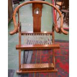A Chinese hardwood folding chair, horseshoe shaped cresting rail terminating in outswept handrests,