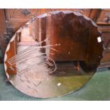 An Art Deco peach glass shaped circular wall mirror, engraved with a heron amongst reeds, 77.