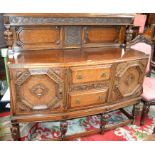 A Jacobean Revival oak sideboard, substantial half-gallery carved and applied with fruiting vine,