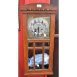 An Art Nouveau oak carved wall clock retailed by Huntley Davie, 17 City Arcades, Birmingham,