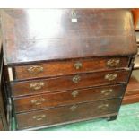 A 19th century oak bureau, fall front enclosing an arrangement of small drawers,