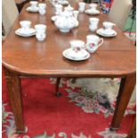 An Arts and Crafts period oak wind-out dining table, two additional leaves, c.