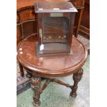 An Elizabethan style oak occasional table, circular top, boldly carved and applied supports,