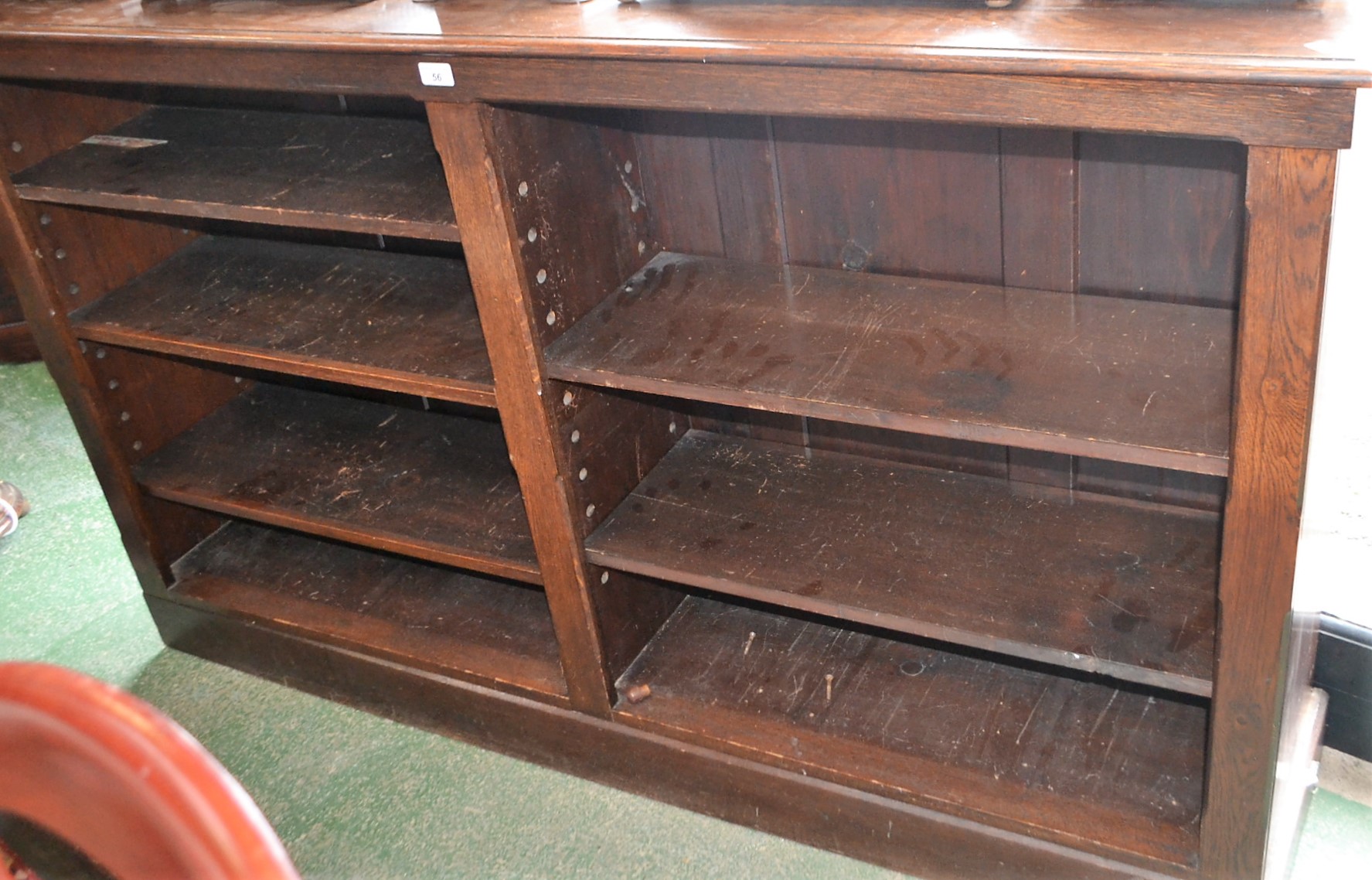 A 20th century oak bookcase, moulded rectangular top above an arrangement of shelves, plinth base,