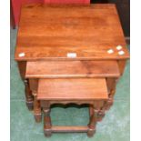 An oak nest of three tables,