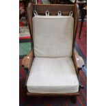 A Rupert/Nigel Griffiths style lambing type armchair, raised and fielded panel wing back,