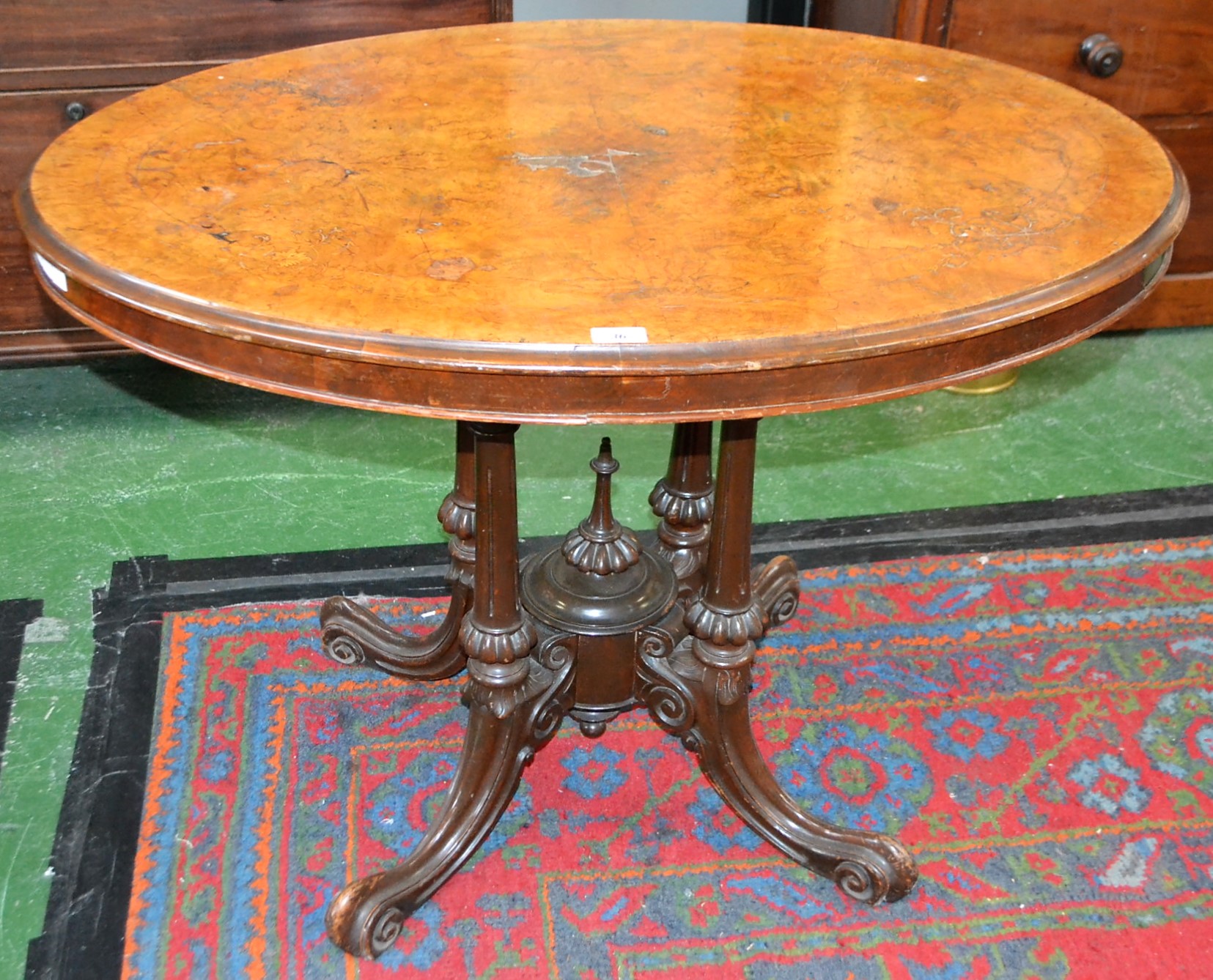 A 19th century walnut centre/loo table, quarter-veneered oval top inlaid with scrolling foliage,