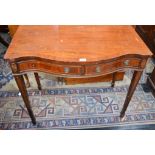 A 20th century mahogany side table, serpentine top above a pair of frieze drawers,
