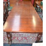 A William IV style mahogany extending dining table, rounded rectangular top, turned legs,
