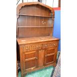 A 20th century oak Welsh type dresser, arched apron above two plate racks,