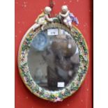 A 19th century Meissen mirror, applied with putti and flowers,