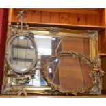 A gilt metal oval girandole type wall mirror,