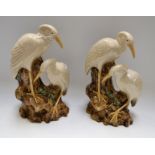 Ceramics - a pair of Oriental studies of cranes, perched on rocky outcrops,