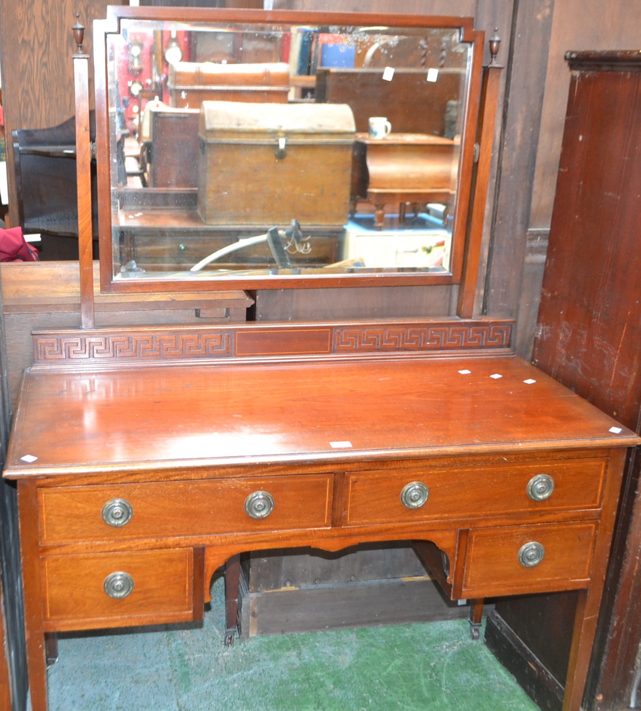 An Edwardian mahogany bedroom suite comprising triple wardrobe,